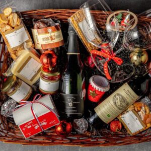 Wooden basket with sparkling wine & delicacies
